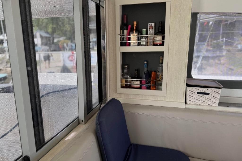 Interior of a 2016 Leopard 404 yacht with a stocked liquor cabinet.