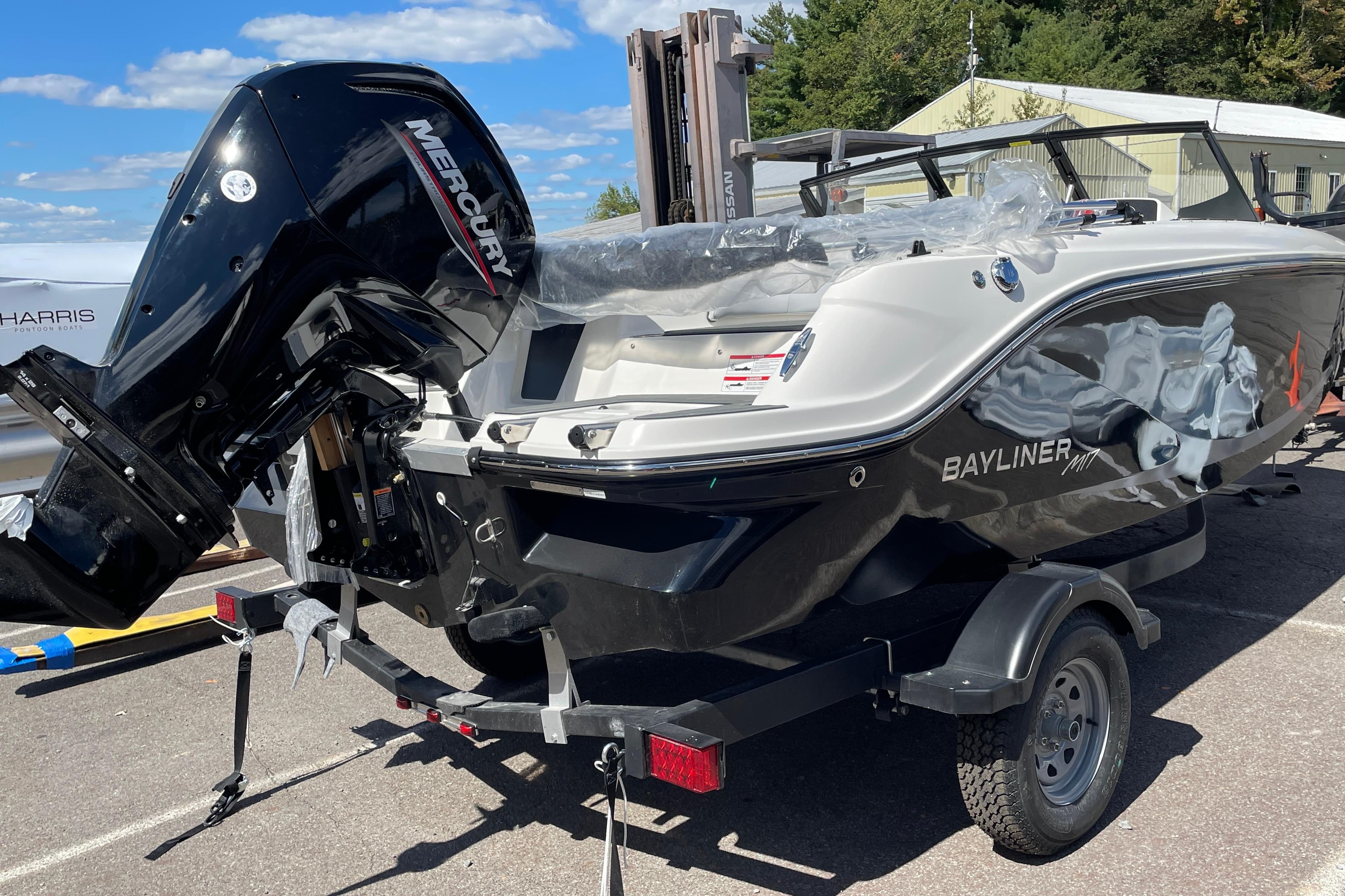 2026 Bayliner Element E17 boat with Mercury engine on trailer, parked outdoors.