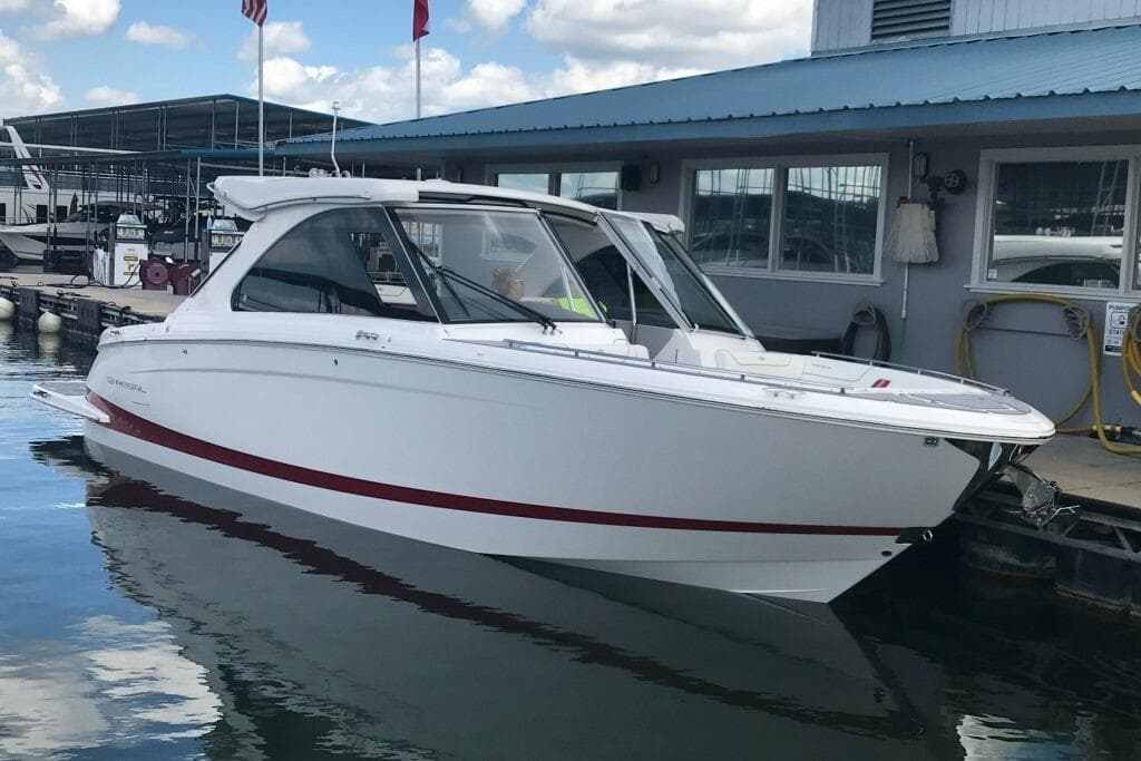 2022 Regal LS36 boat docked at marina under blue sky.