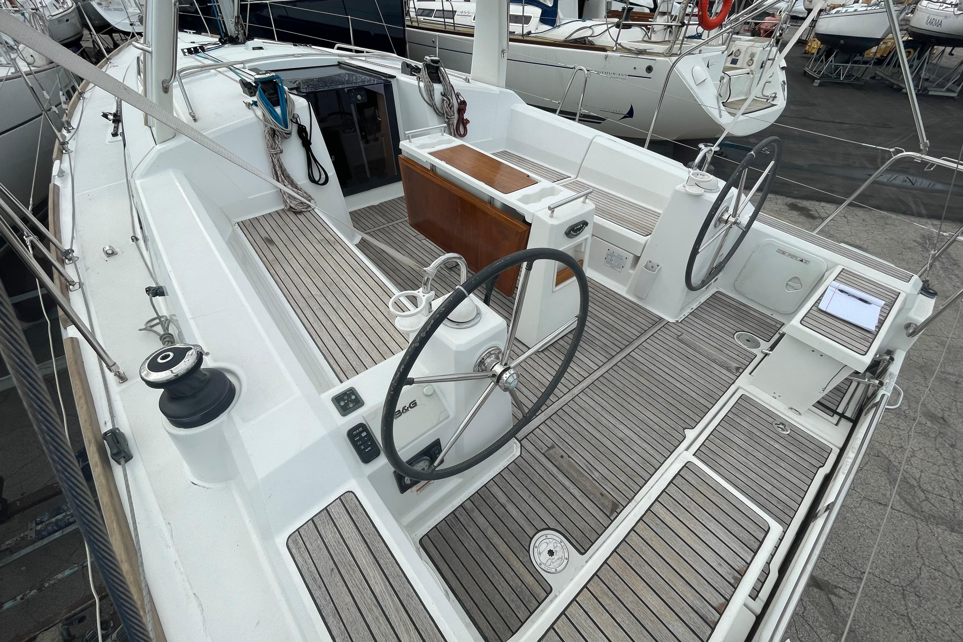 2016 Beneteau Oceanis 38 sailboat cockpit with dual steering wheels and teak decking.