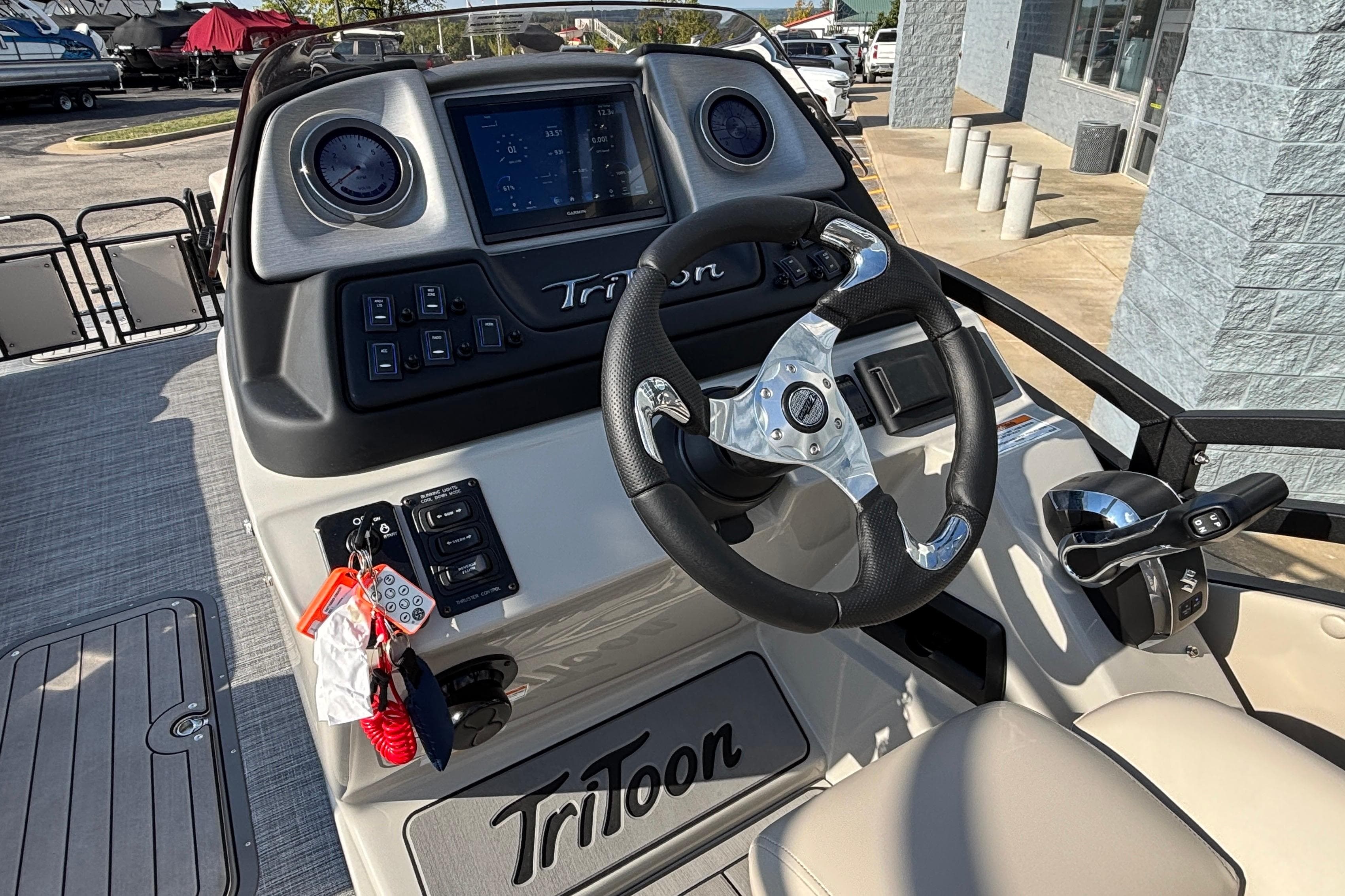 Steering console of 2026 JC Neptoon 25TT Sport boat with modern controls and display.