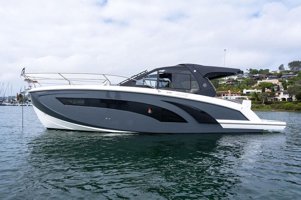 Modern Hanover 387 yacht from 2027 on calm water, with scenic coastal background.