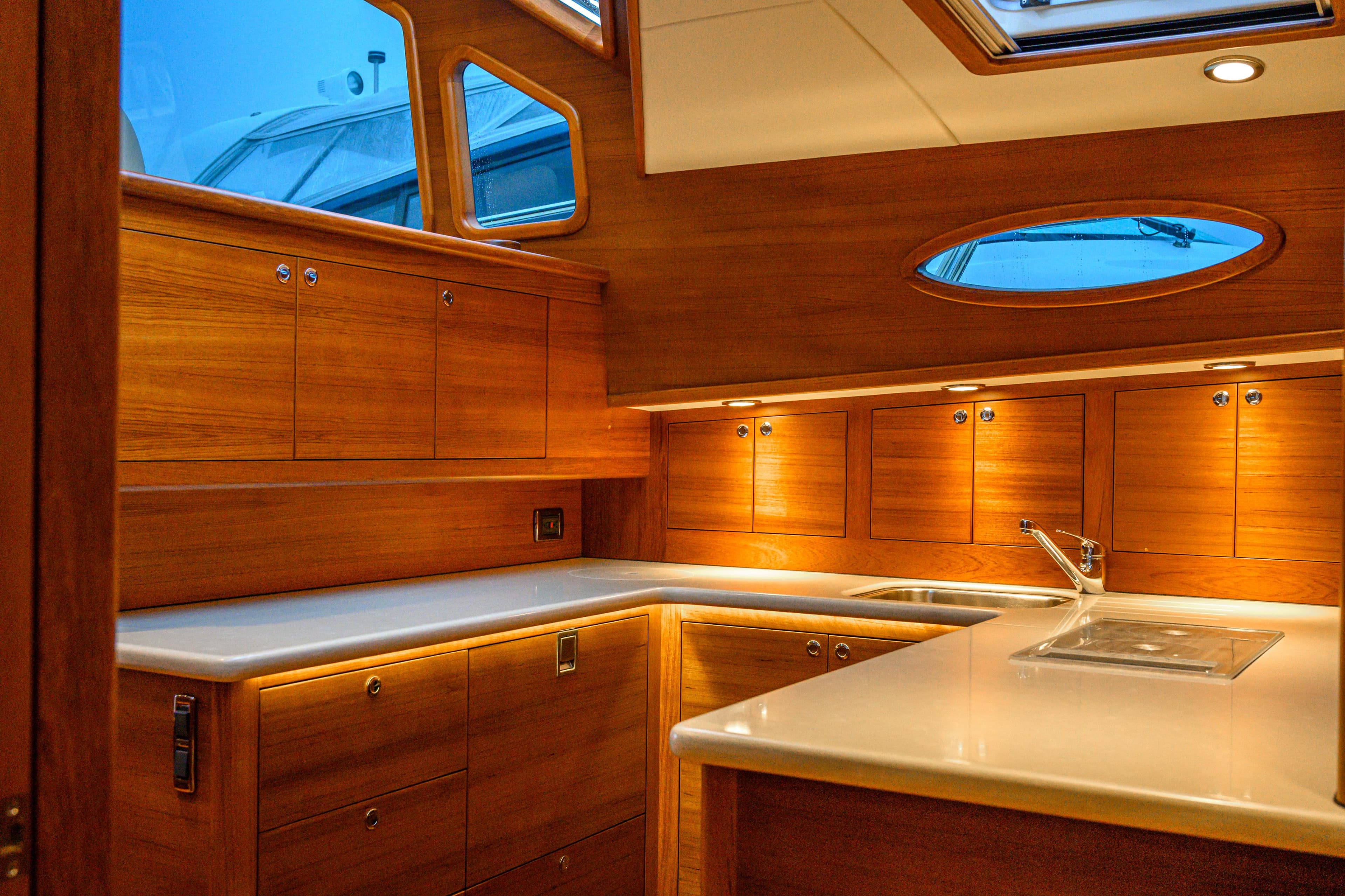 Luxurious 2020 Palm Beach Motor Yachts PB52 interior with elegant wood cabinetry and modern fixtures.