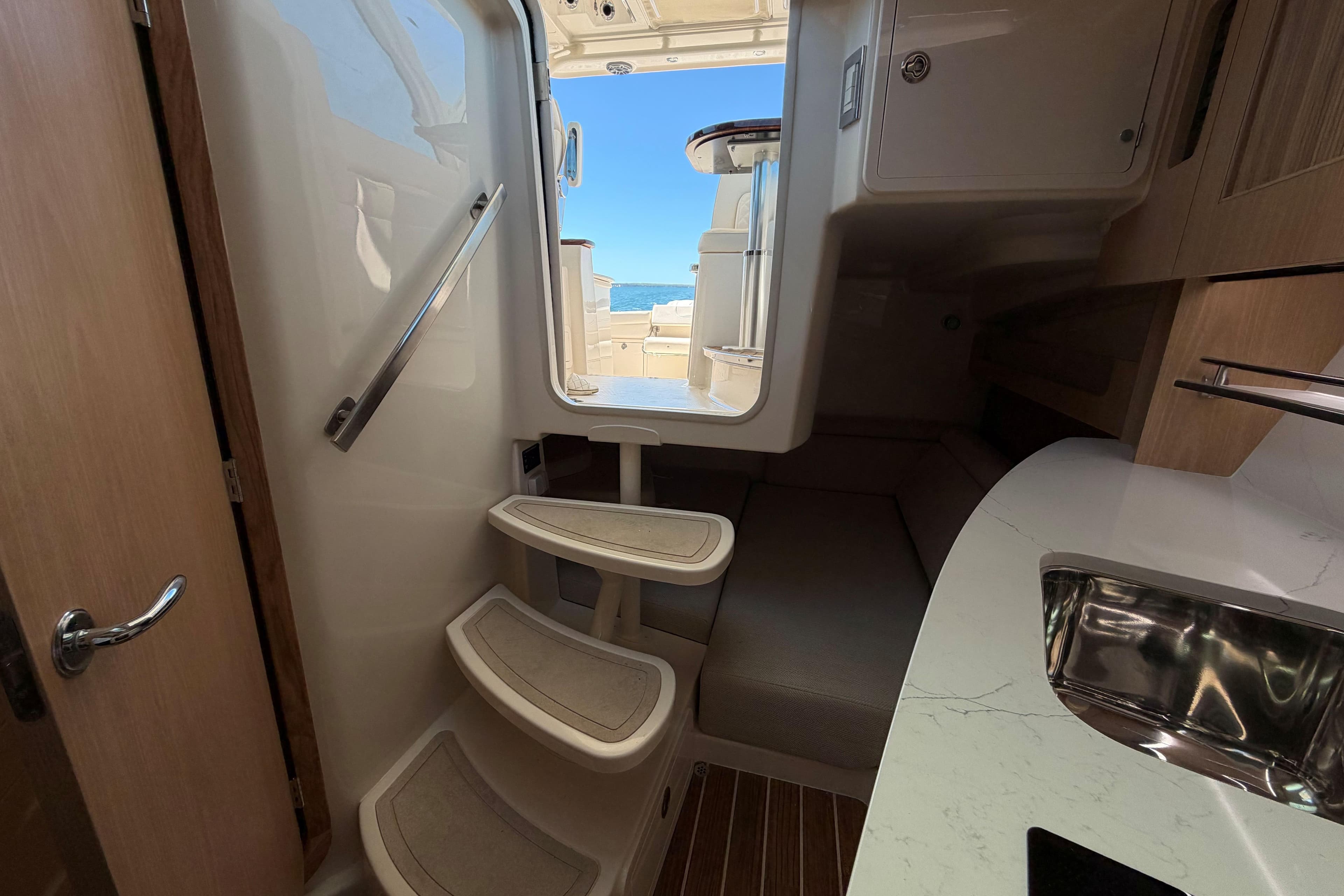 Interior of 2026 Grady-White Express 340 boat, featuring stairs and compact cabin space.