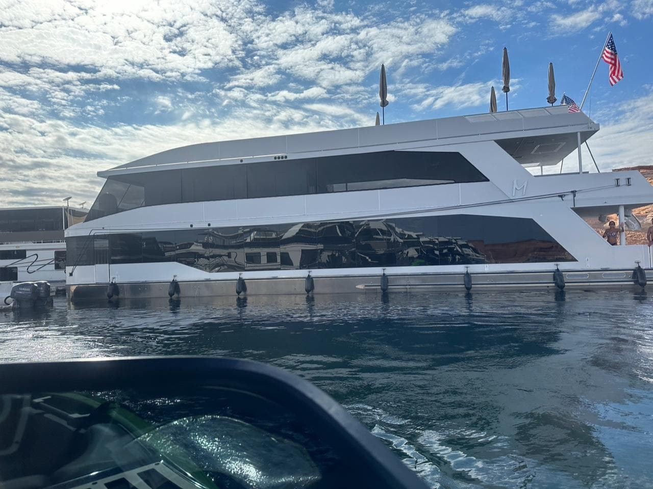 Luxury yacht Adonia Meticulous Share #7, 2023 model, docked under a bright blue sky.