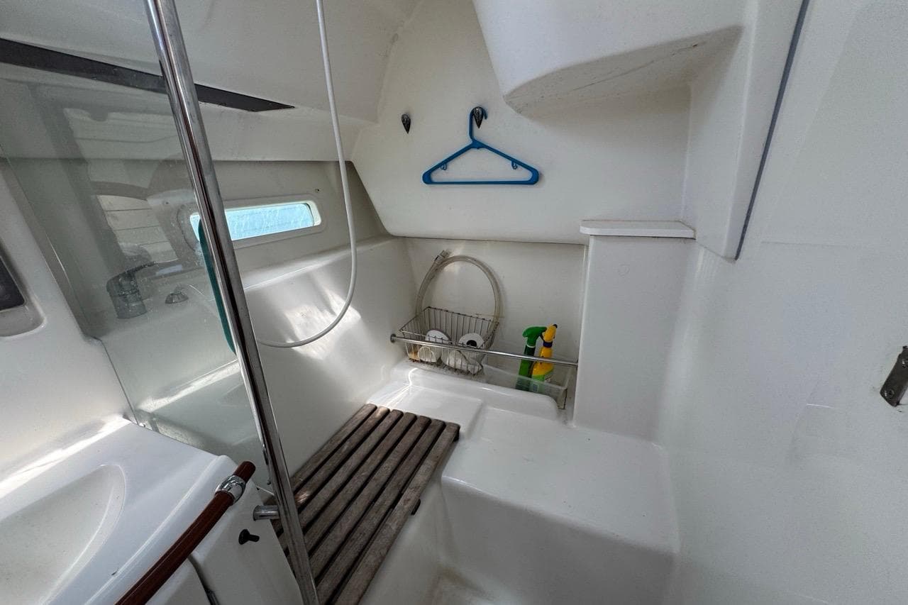 Interior of 2005 Beneteau Oceanis Clipper 373 yacht bathroom with shower and storage.