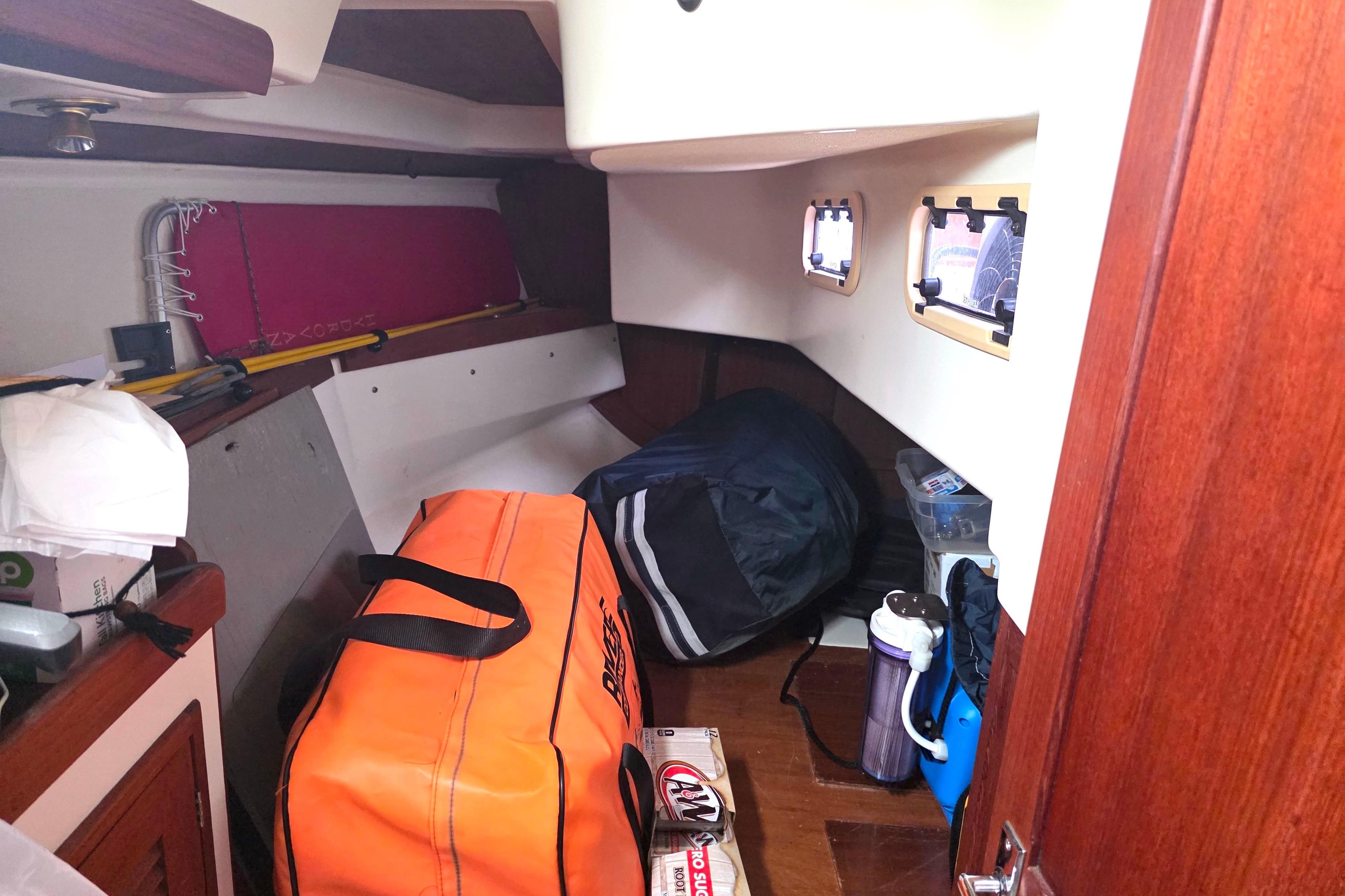 Interior cabin of a 1990 Tartan 372 sailboat with storage bags and equipment.