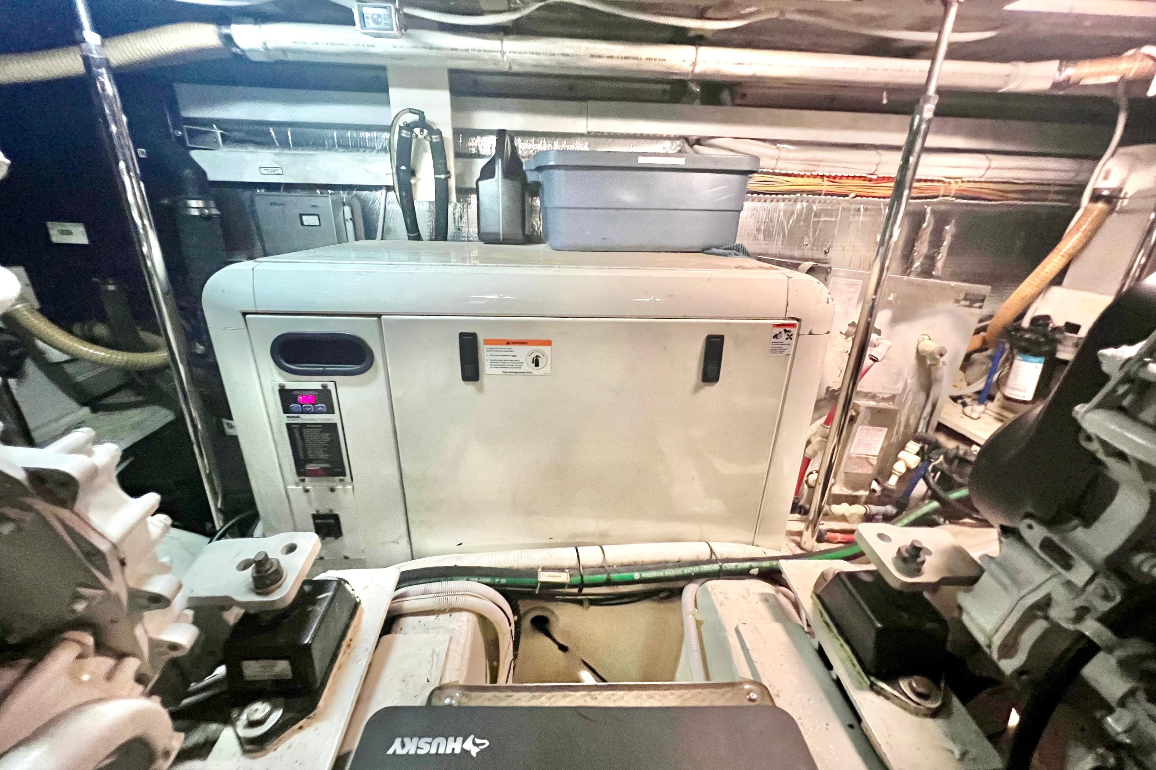 Engine room of a 2005 Carver 56 Voyager yacht, featuring machinery and equipment.