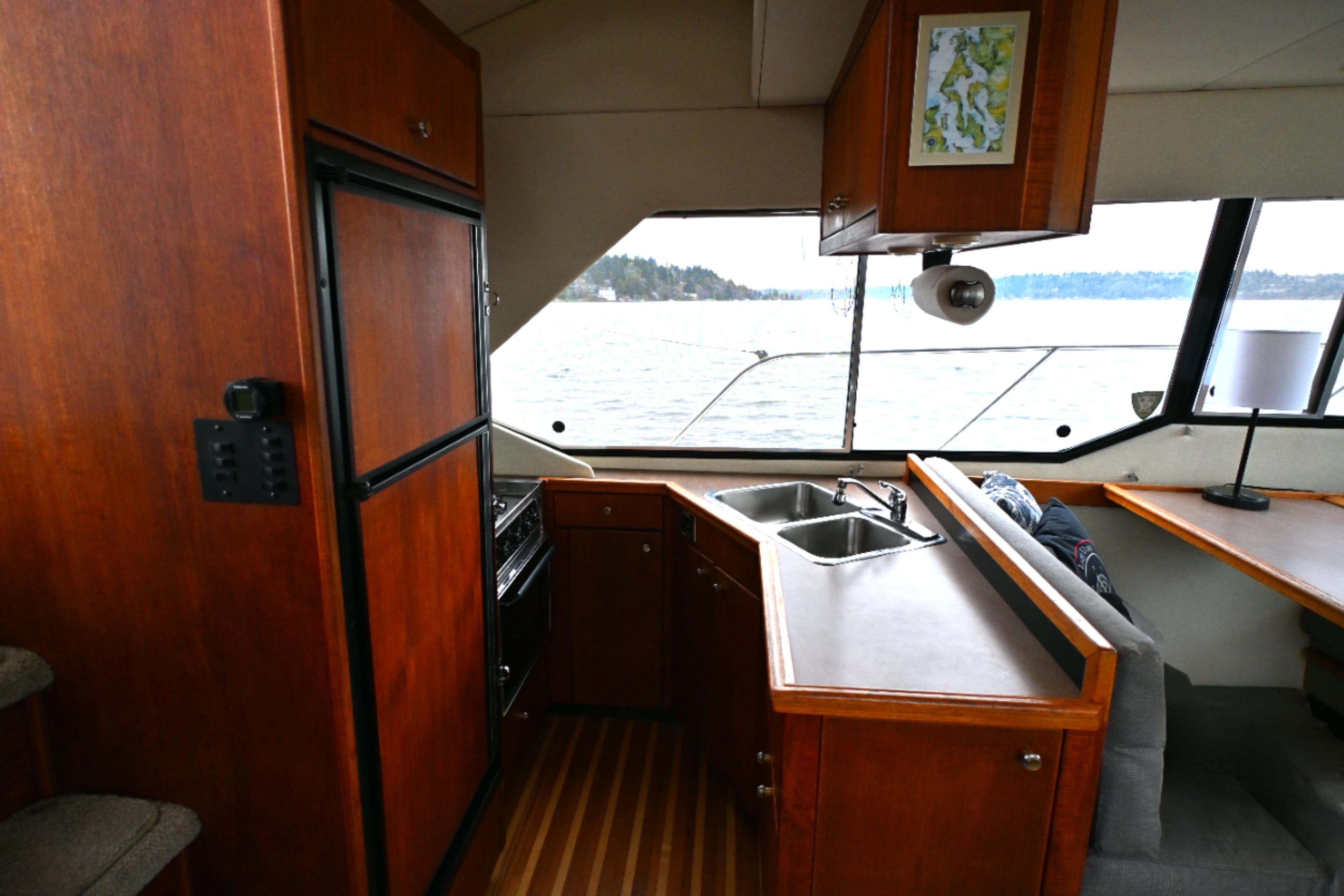 1996 Bayliner 4087 Aft Cabin Motoryacht interior with kitchen and seating area.