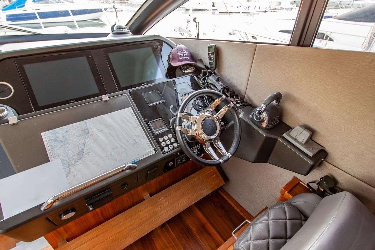 Cockpit of 2015 Sunseeker Predator 57 yacht with steering wheel and navigation equipment.