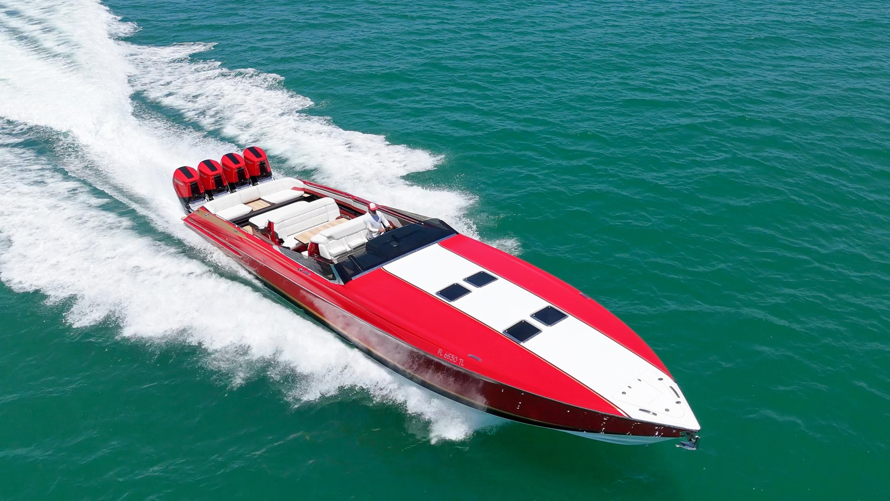 2023 Nor-Tech 55 Flyer speedboat cruising on open water, featuring a sleek red and white design.