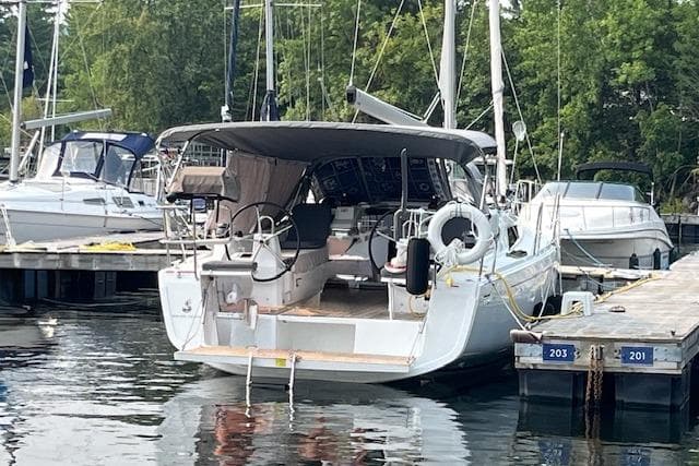 2023 Beneteau Oceanis 34.1 yacht docked at marina, surrounded by other boats.