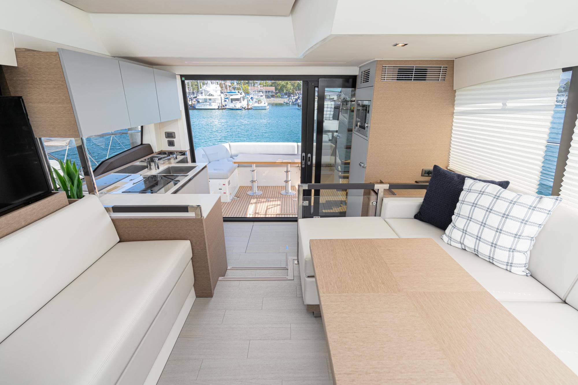 Interior of 2022 Prestige 460 yacht with modern seating and kitchen area.