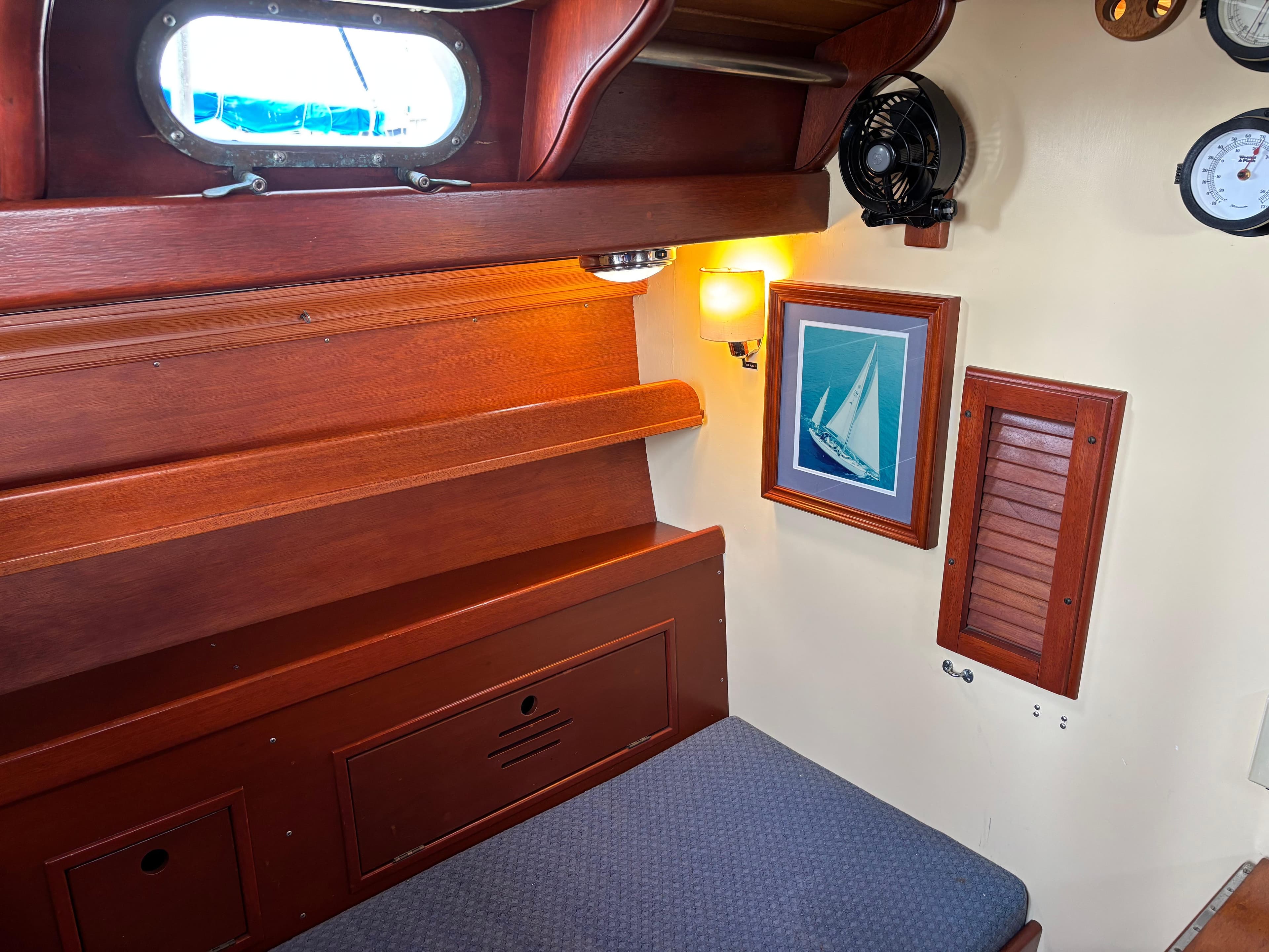 1955 Hinckley 36 Auxiliary Yawl cabin interior with wooden finish and nautical decor.