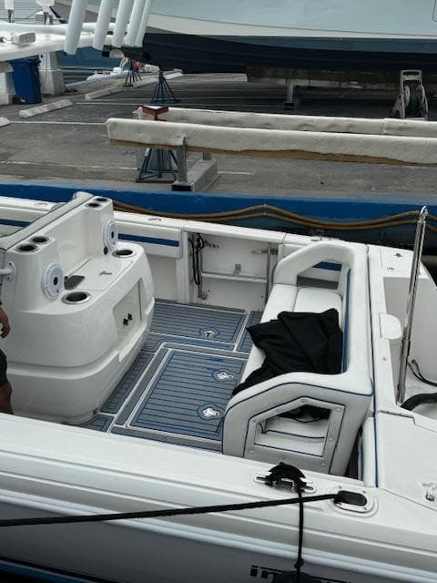 2008 Intrepid Open boat interior at dock, featuring seating and storage areas.