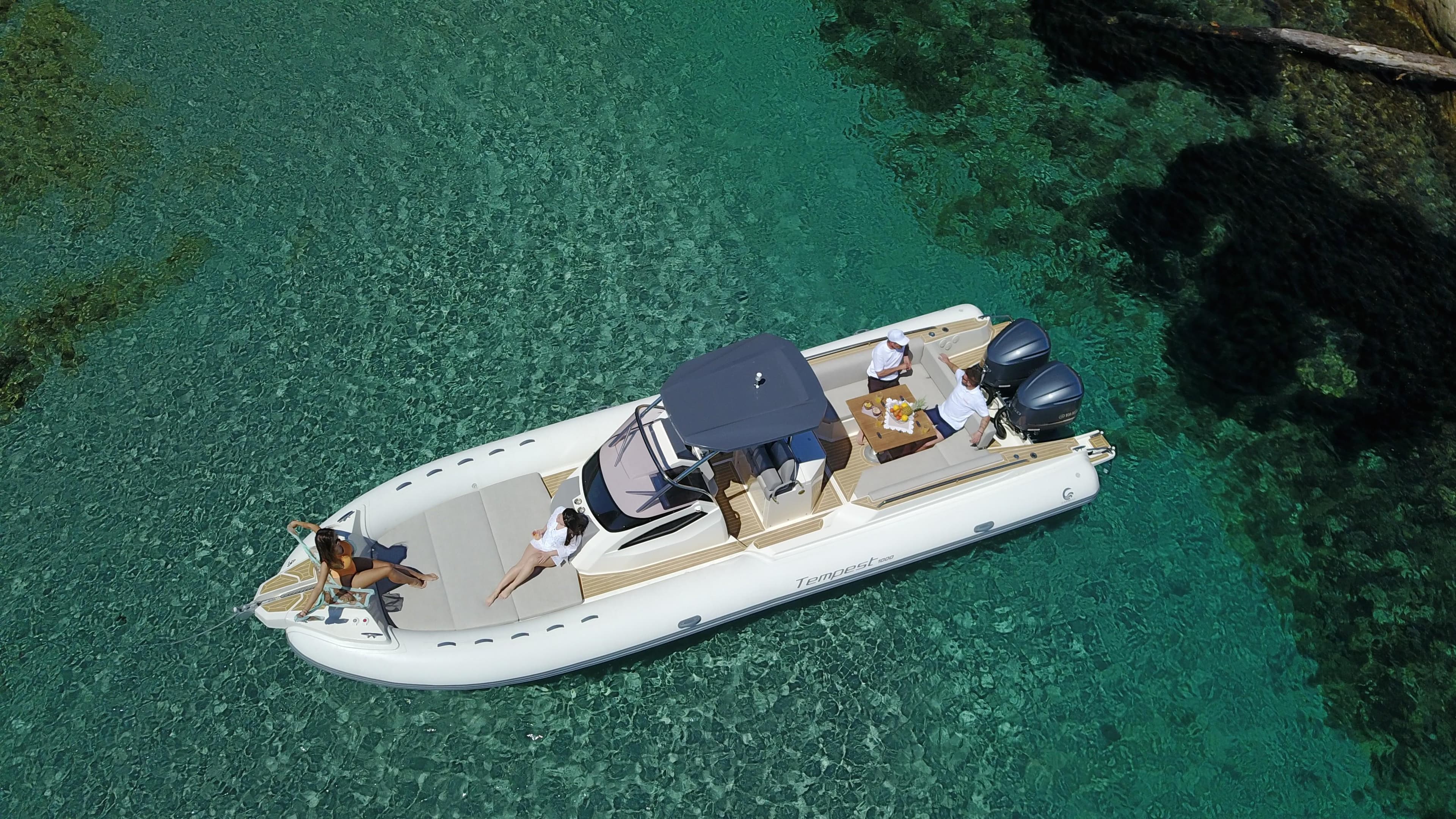 2025 Capelli Tempest 1000 CC boat cruising on clear turquoise water.