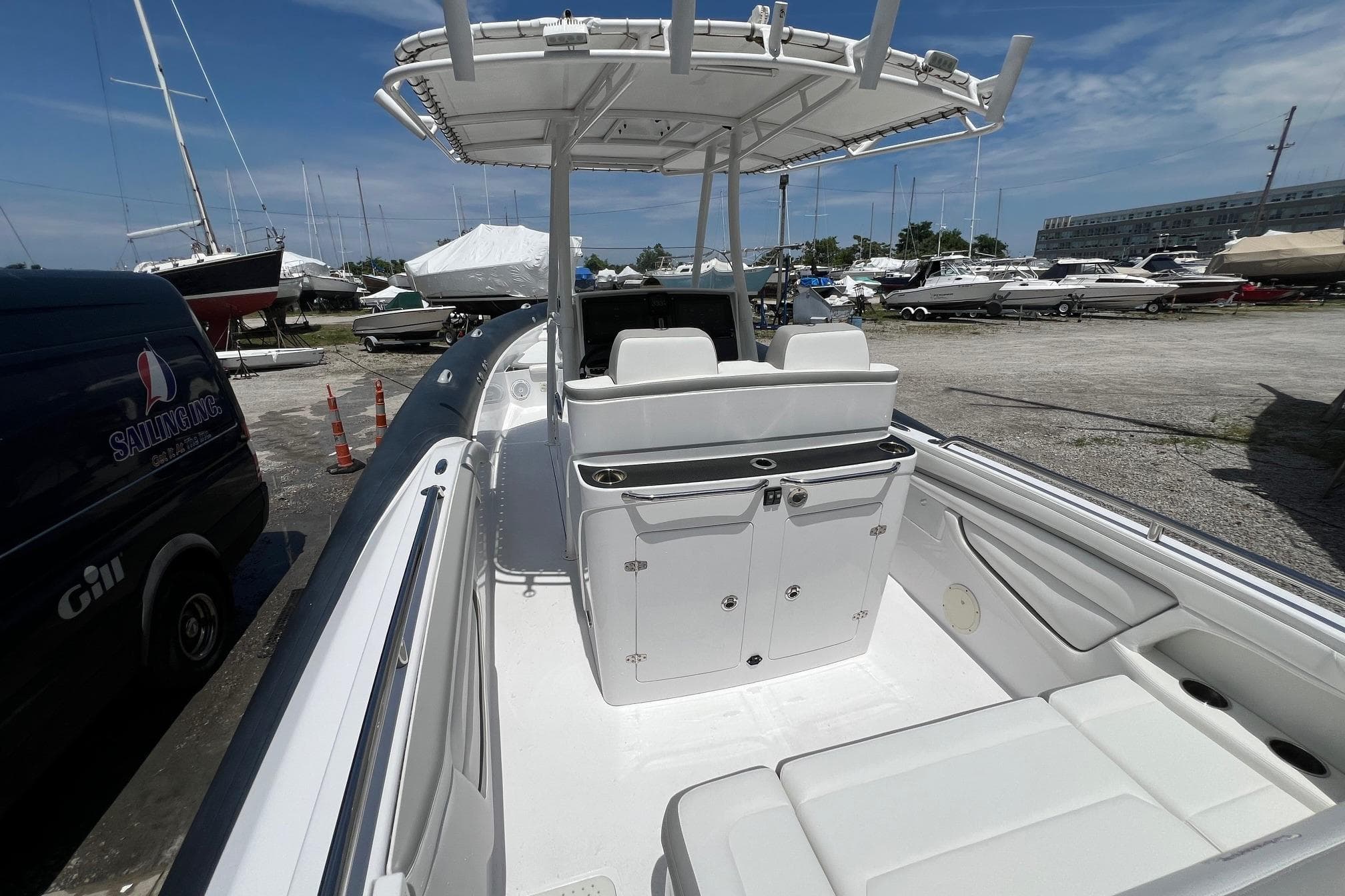 2015 Airship 330 boat with seating and storage, docked in a marina under a clear sky.