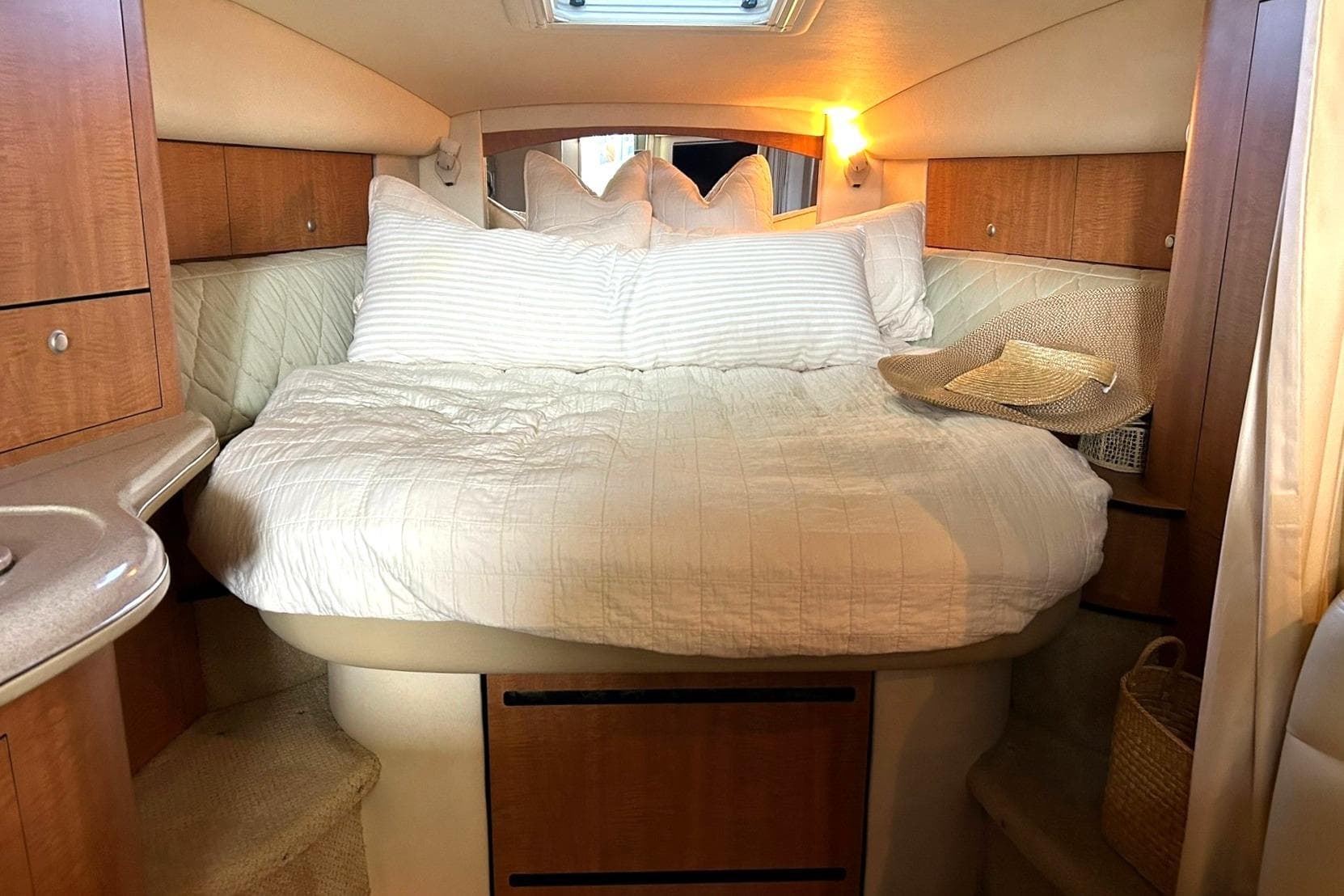 Interior cabin of 2006 Sea Ray Sundancer 320 with cozy bed and soft lighting.