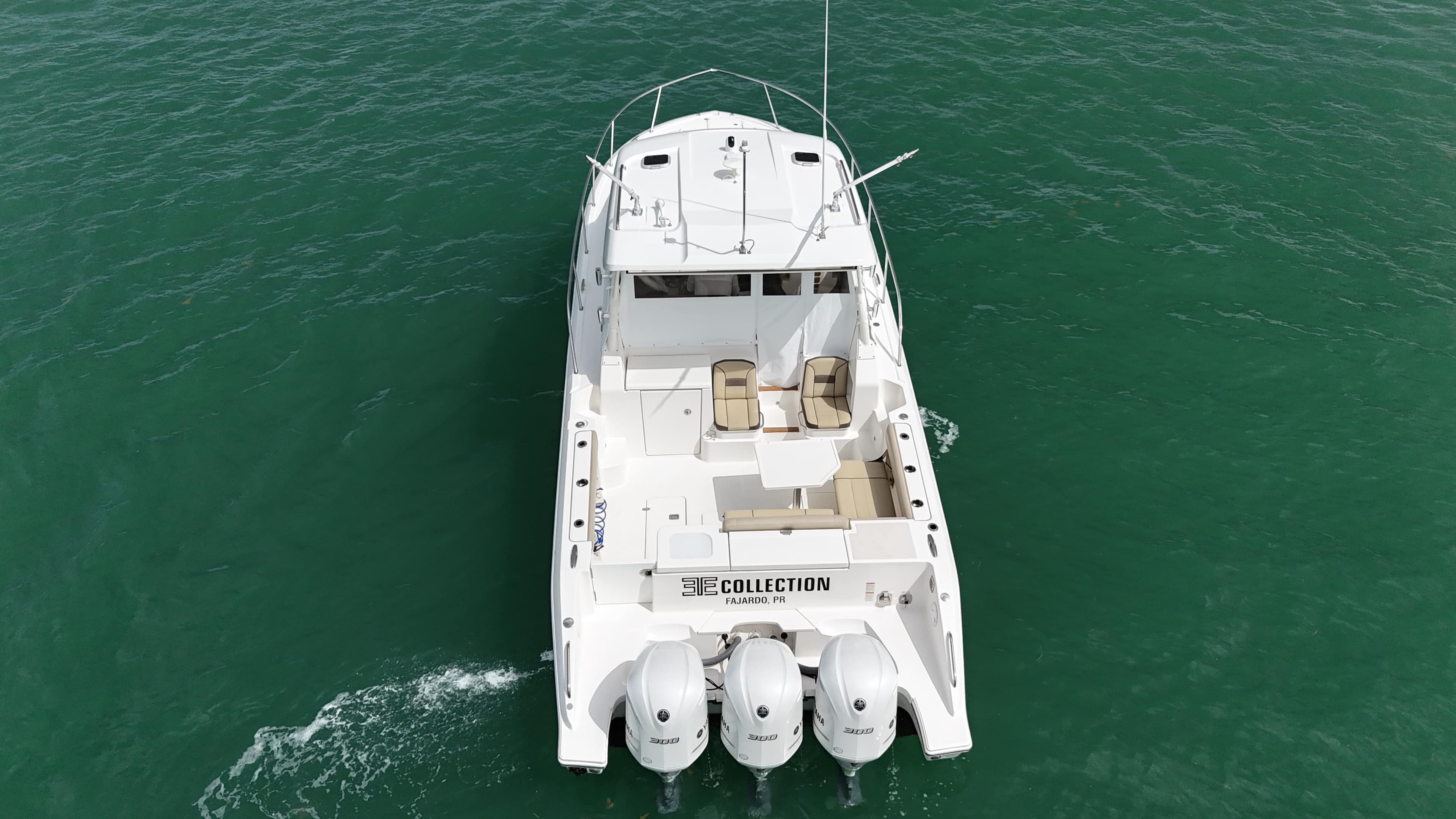 2019 Pursuit OS 355 Offshore boat cruising on clear green water.