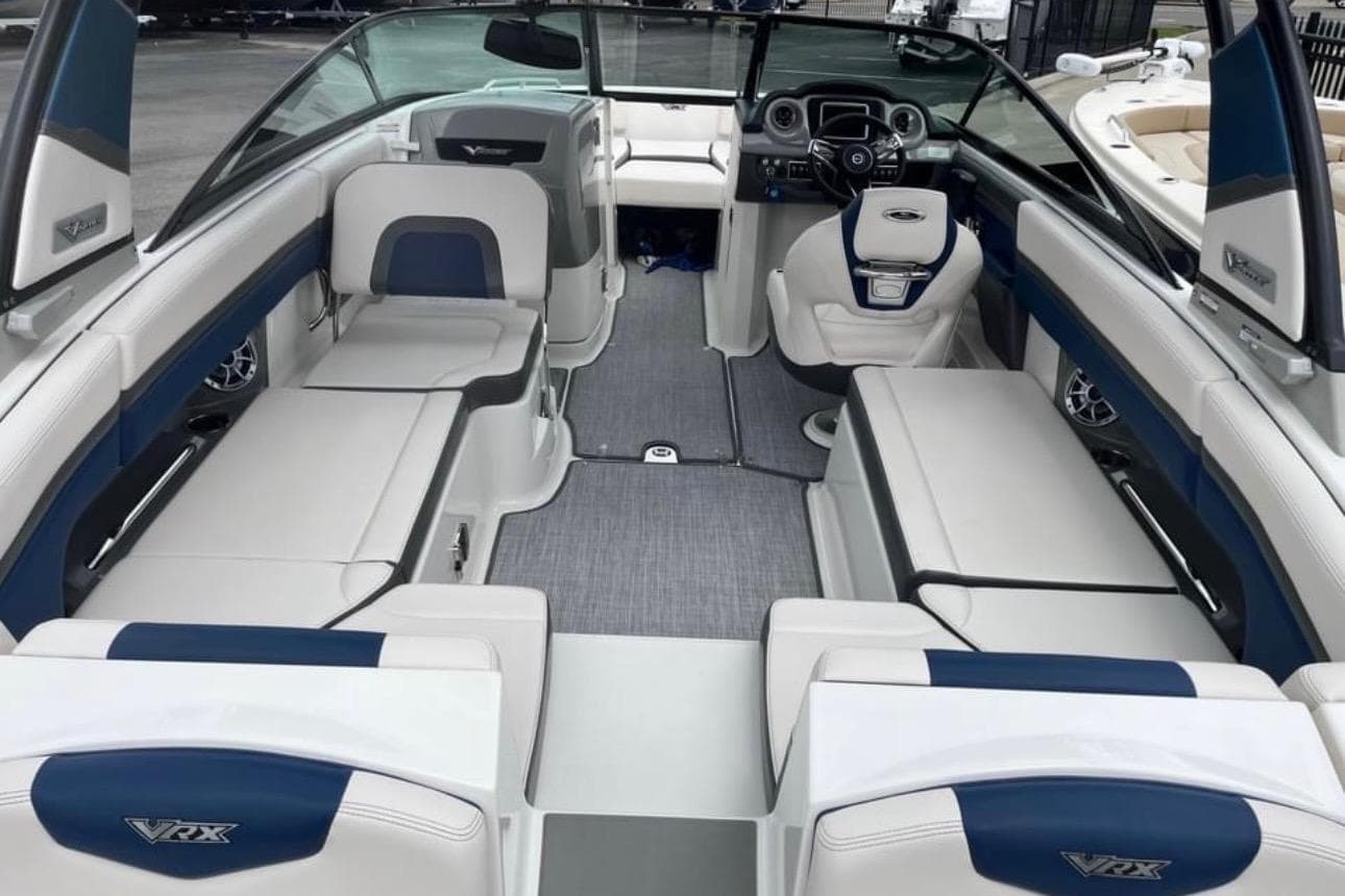 2016 Chaparral Vortex 243 VRX boat interior with blue and white seating and modern dashboard.