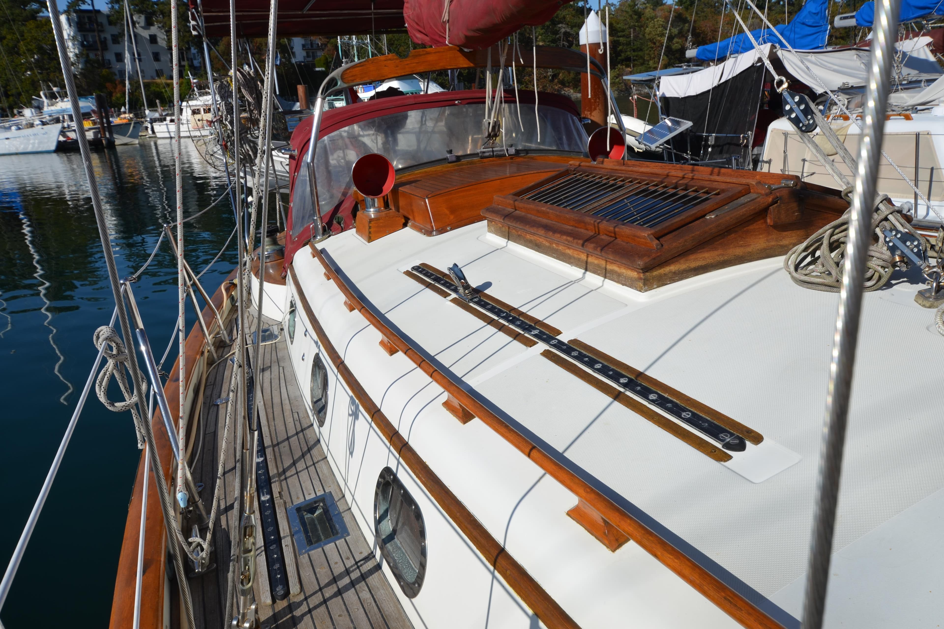 1982 Ta Shing Panada sailboat deck with wooden accents and marina background.