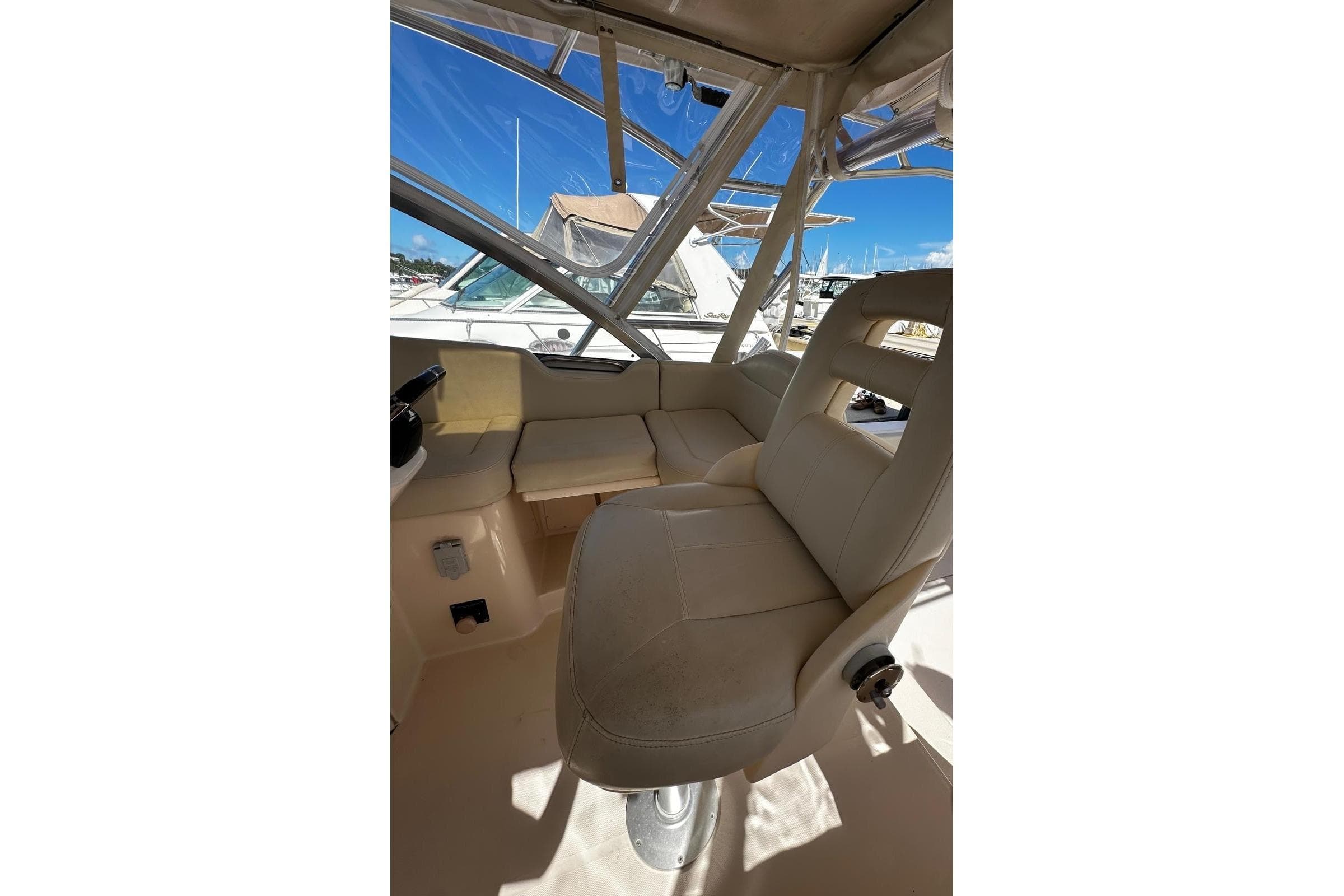 2008 Grady-White Express 330 boat interior with beige seating and clear windows.