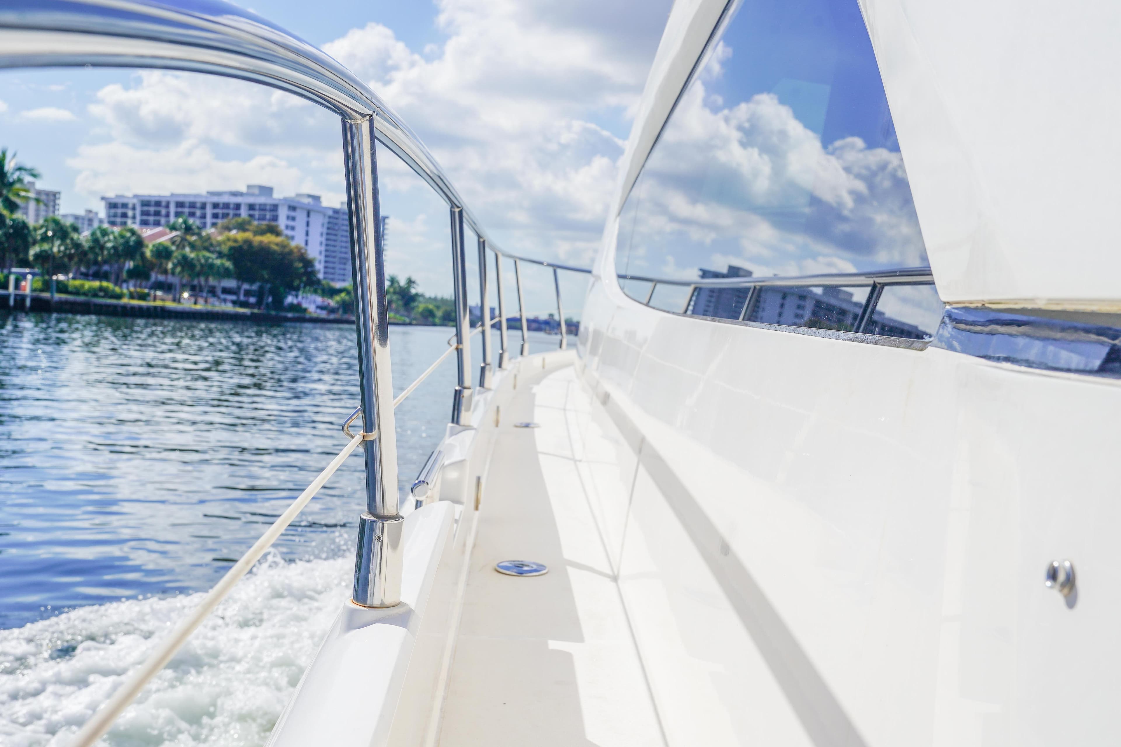 Side view of 2009 Fairline 48 Phantom yacht cruising on a sunny day.