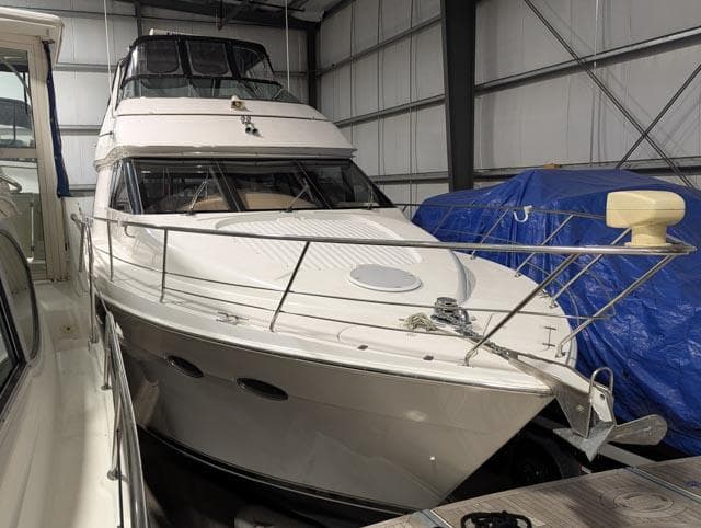1999 Carver 530 Voyager Pilothouse yacht docked in a storage facility.