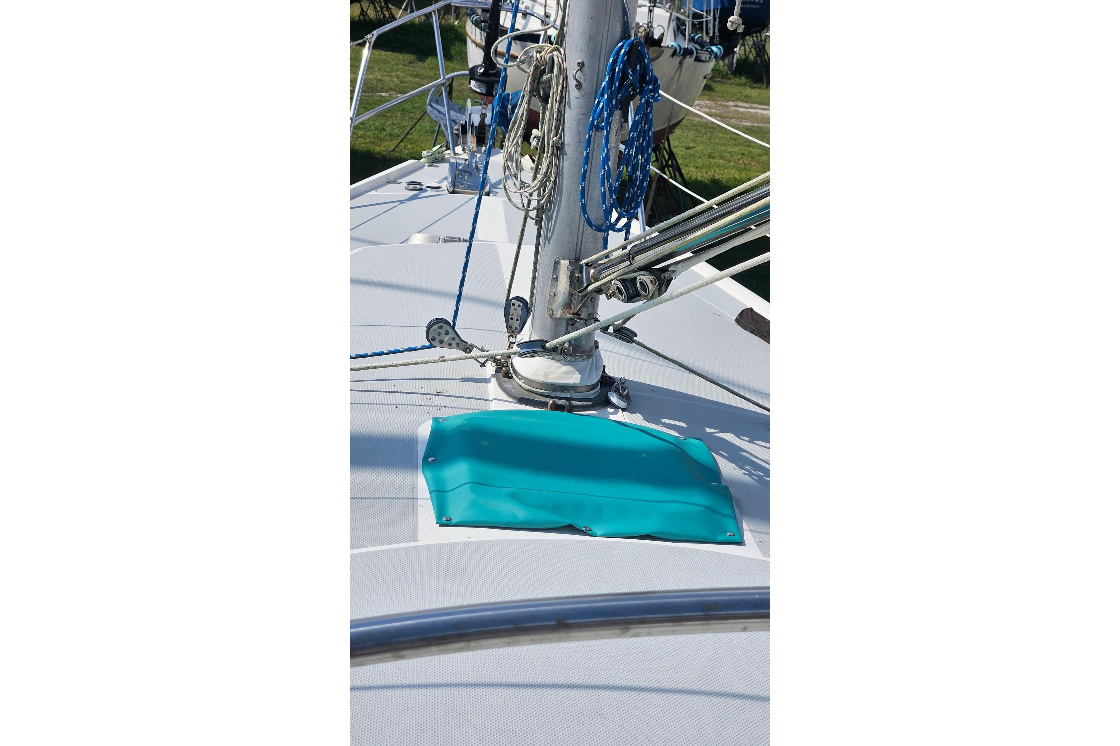 1988 Catalina 34 sailboat deck with mast and turquoise cover.