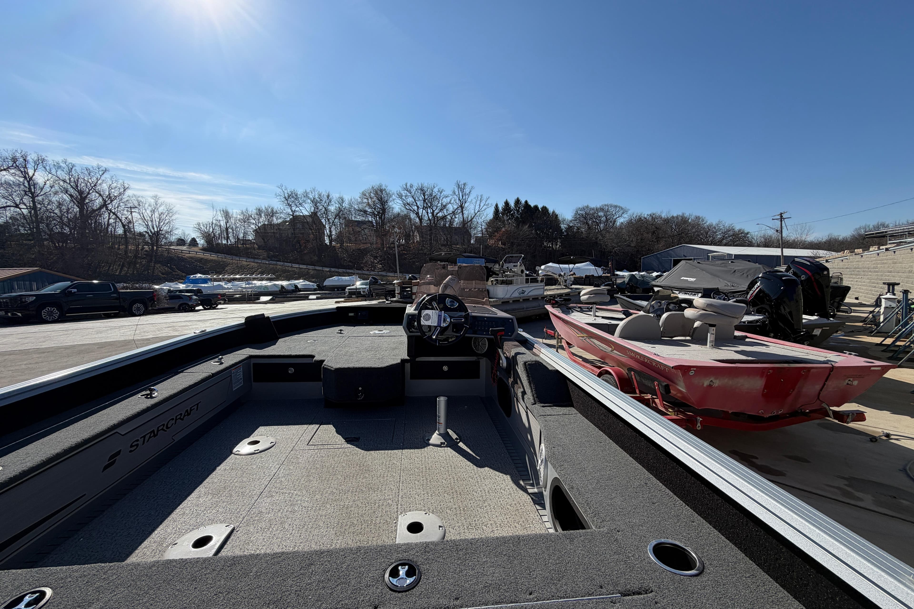 2023 Starcraft Delta 178 SC Pro boat in outdoor showroom under clear blue sky.