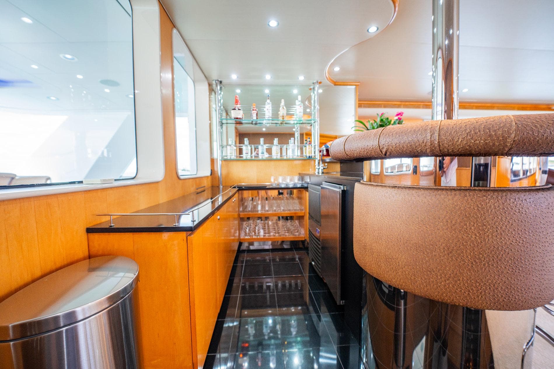 Luxurious bar area on 1996 Cheoy Lee 145 Global Series yacht with modern design.