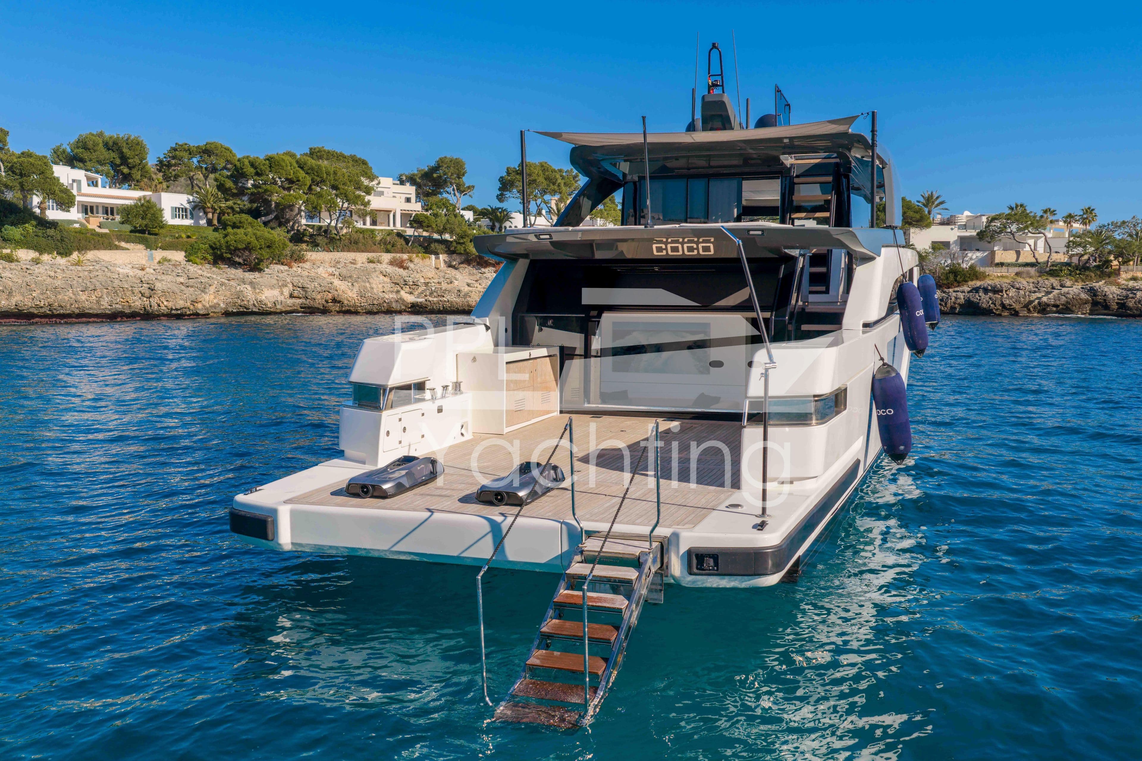 2024 Bluegame BGX63 yacht docked in scenic coastal waters.
