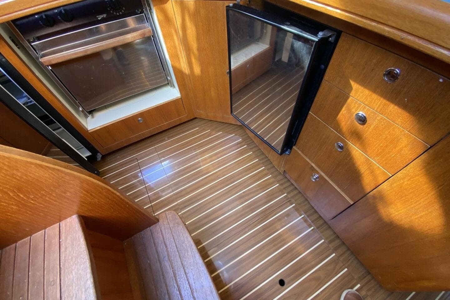 Interior of 2004 Hunter 41 AC yacht with wooden cabinetry and flooring.