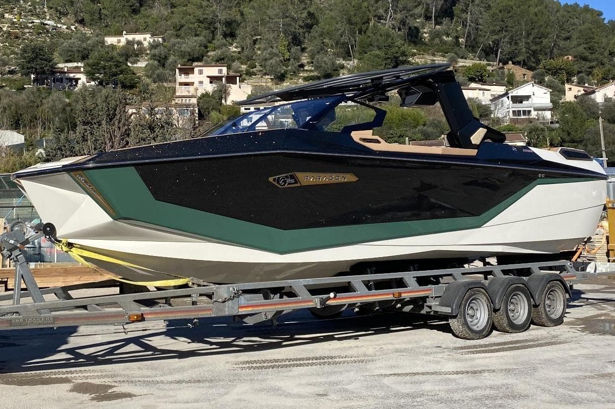 2024 Nautique Ski Nautique boat on trailer, sleek design, parked outdoors.