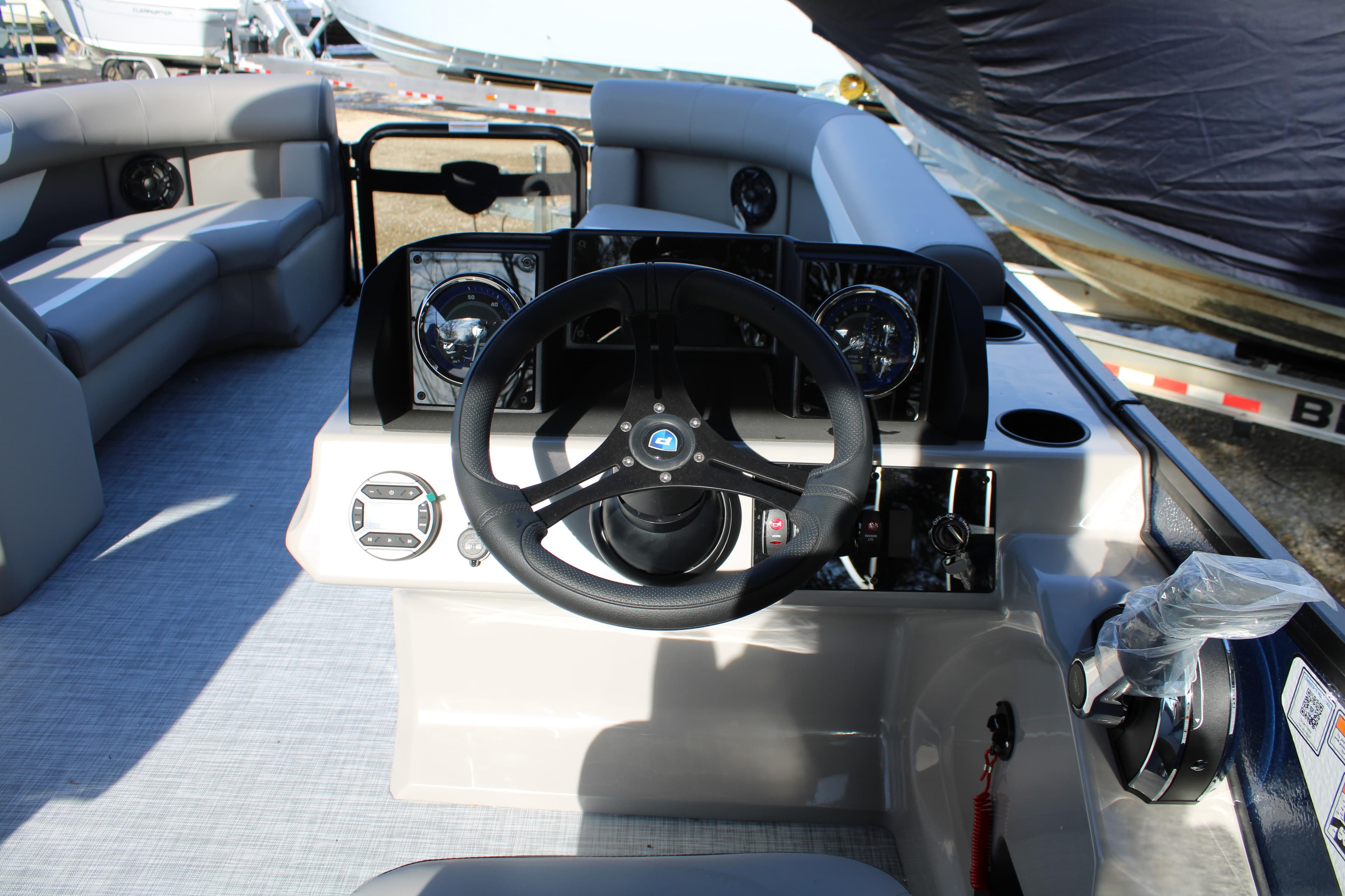 2026 Premier 220 Sunscape RF boat interior with steering wheel and dashboard controls.