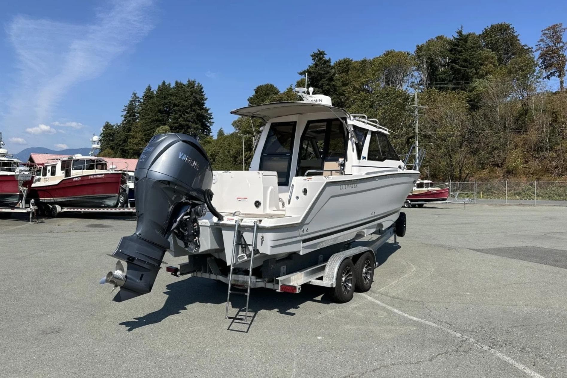 2026 Cutwater C-248 Coupe boat on trailer, parked outdoors under clear sky.