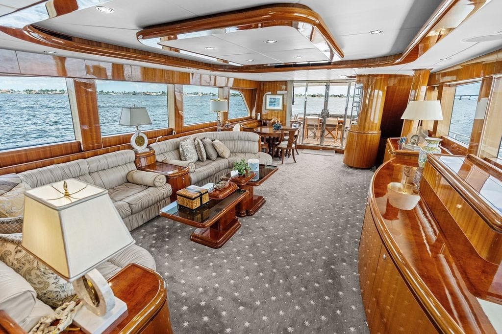 Luxurious 2005 Horizon 82 yacht interior with elegant wood finishes and plush seating.