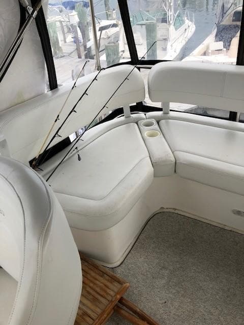 2004 Silverton 34C boat interior with white seating and fishing rods.