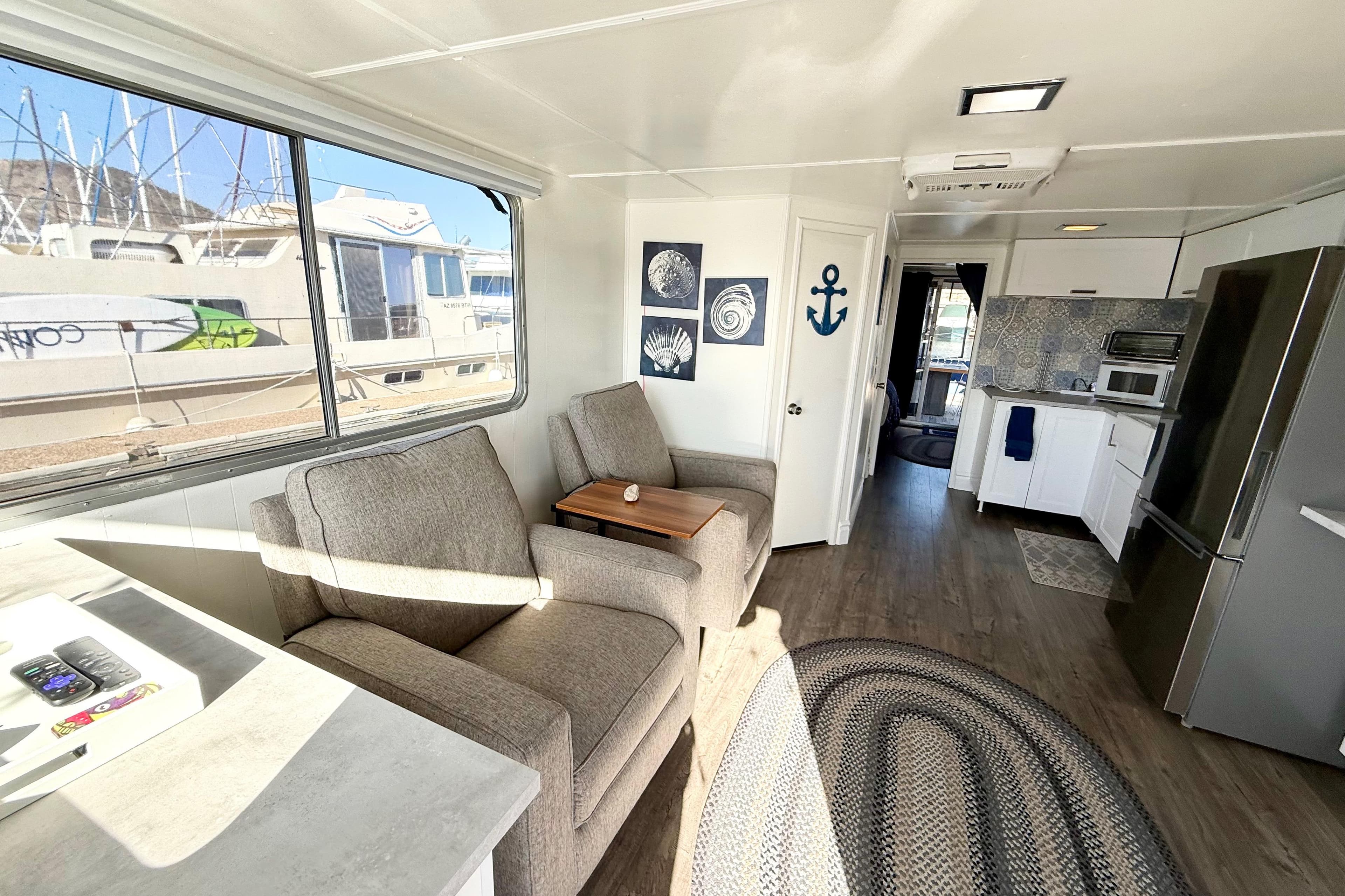 Interior of 1986 Hilburn 4014 Executive houseboat with modern decor and comfortable seating.