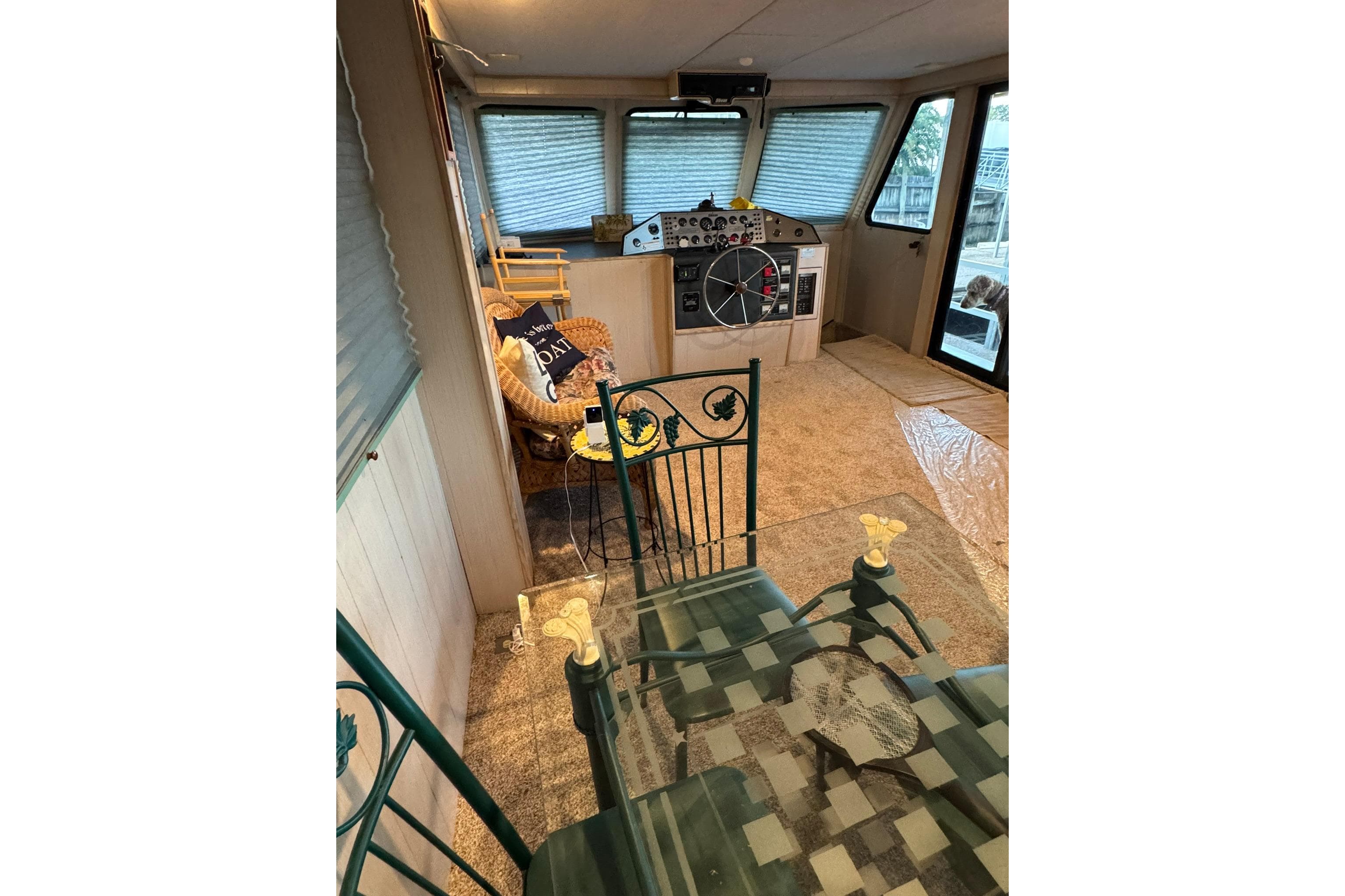 Interior of 1996 Gibson 50 Cabin Yacht with helm, seating, and glass table.