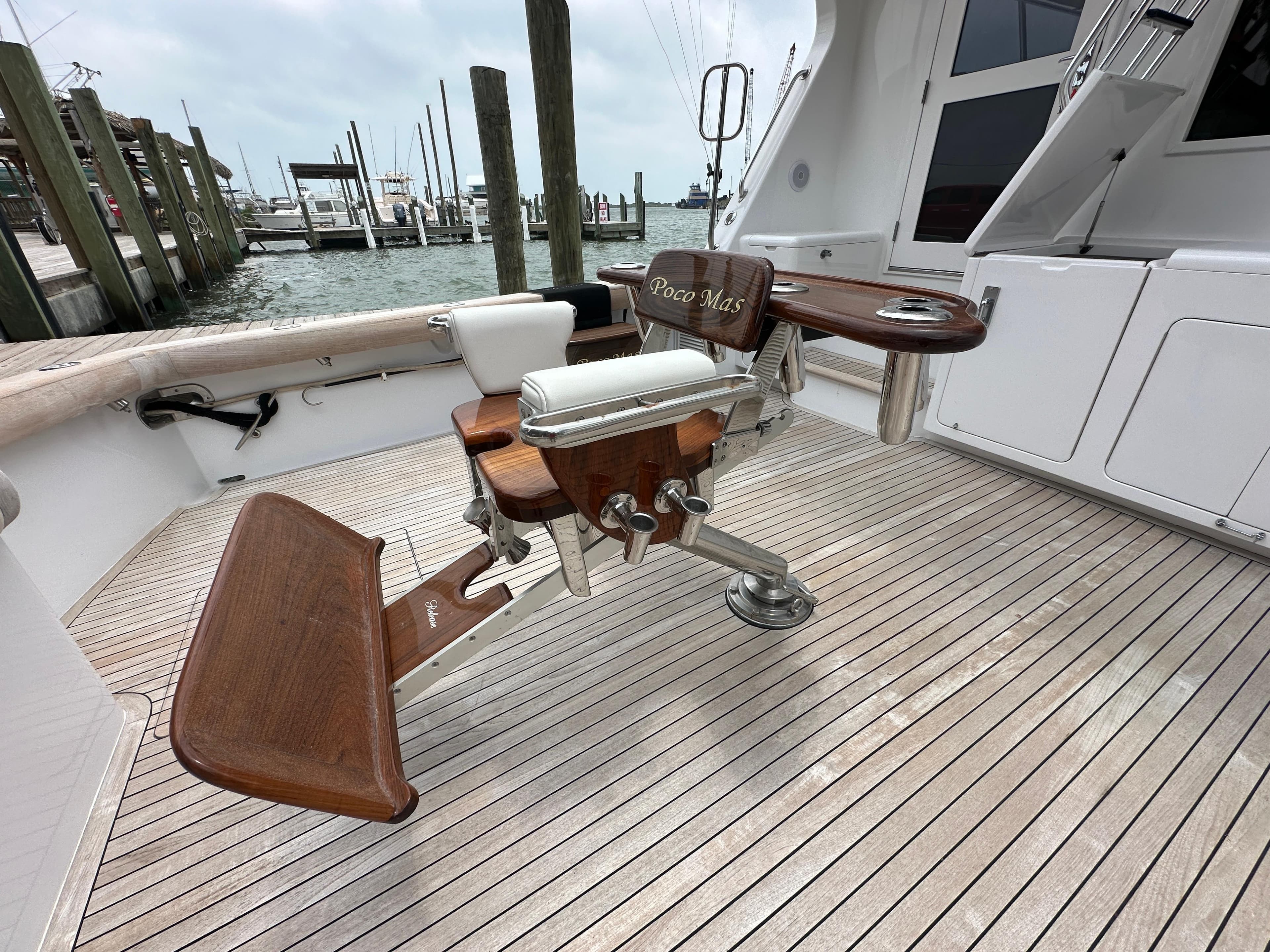 1996 Donzi Custom Enclosed Flybridge boat deck with fishing chair and rod holders.