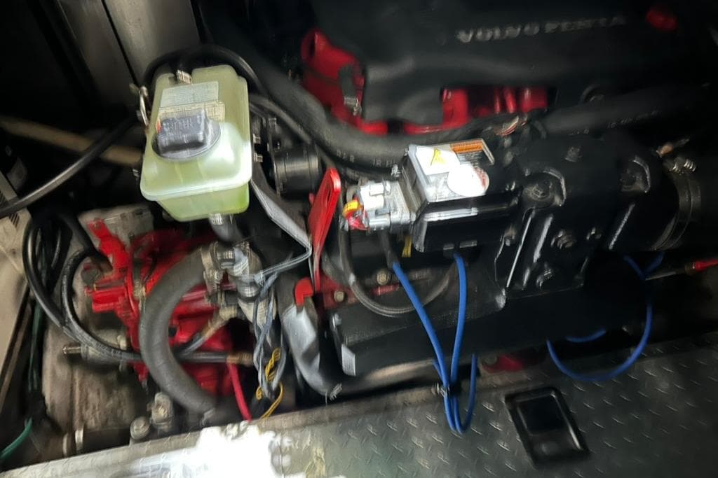 Engine compartment of a 2002 Four Winns 378 Vista boat, featuring Volvo Penta components.