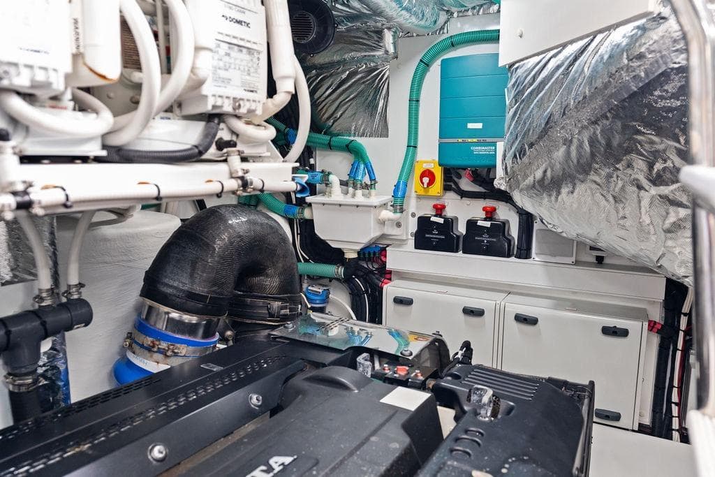 Engine room of 2021 Princess V55 yacht, showcasing mechanical components and systems.