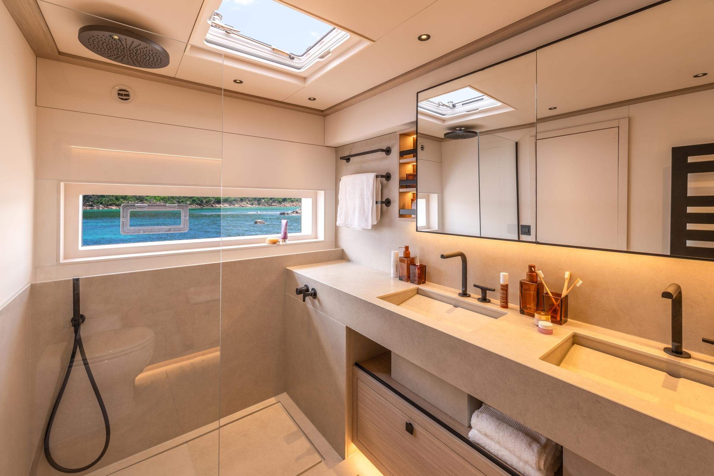Luxurious bathroom in 2025 Lagoon Eighty 2 yacht with ocean view and modern fixtures.
