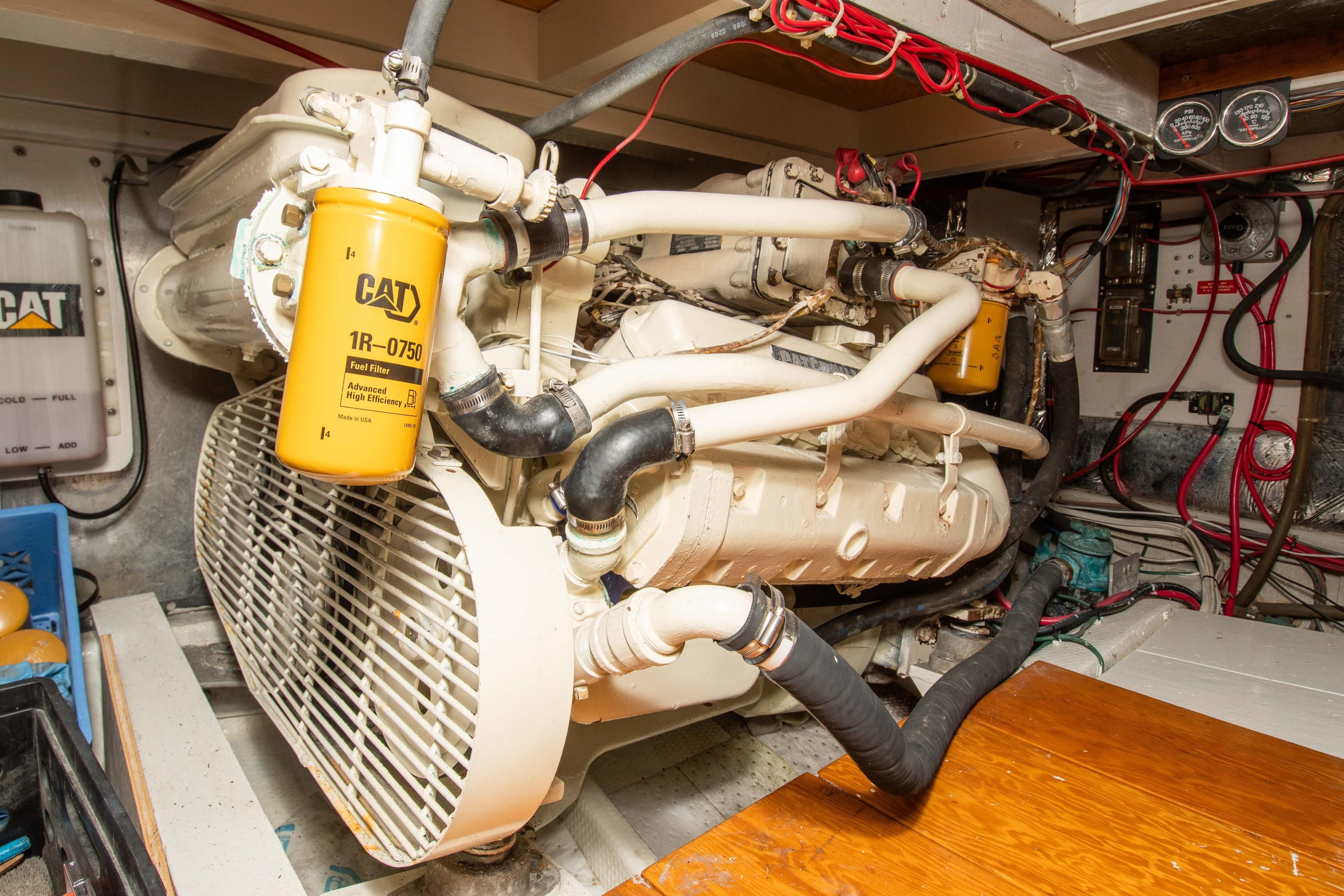 Engine room of a 1989 Chris-Craft Catalina boat with CAT components and wiring.