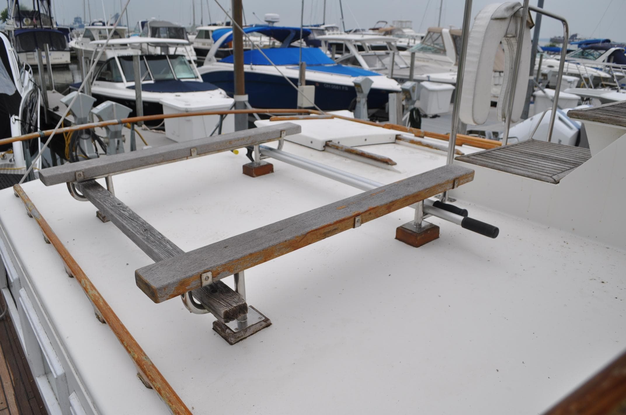 1983 Grand Banks 42 Classic yacht deck with boat cradle in marina.