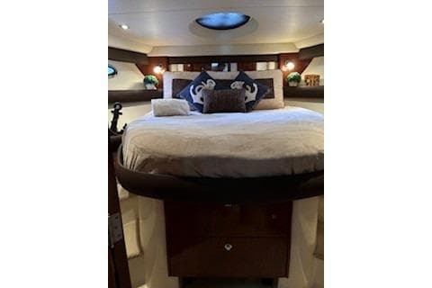 Luxurious bedroom interior of 2009 Meridian 391 Sedan yacht with elegant bedding.