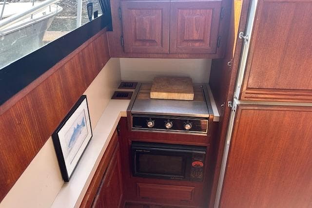 1988 Viking 45 Convertible yacht kitchen with wooden cabinets and modern appliances.