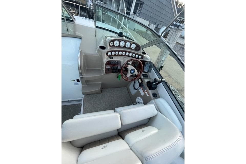 2005 Four Winns 288 Vista boat cockpit with steering wheel and instrument panel.