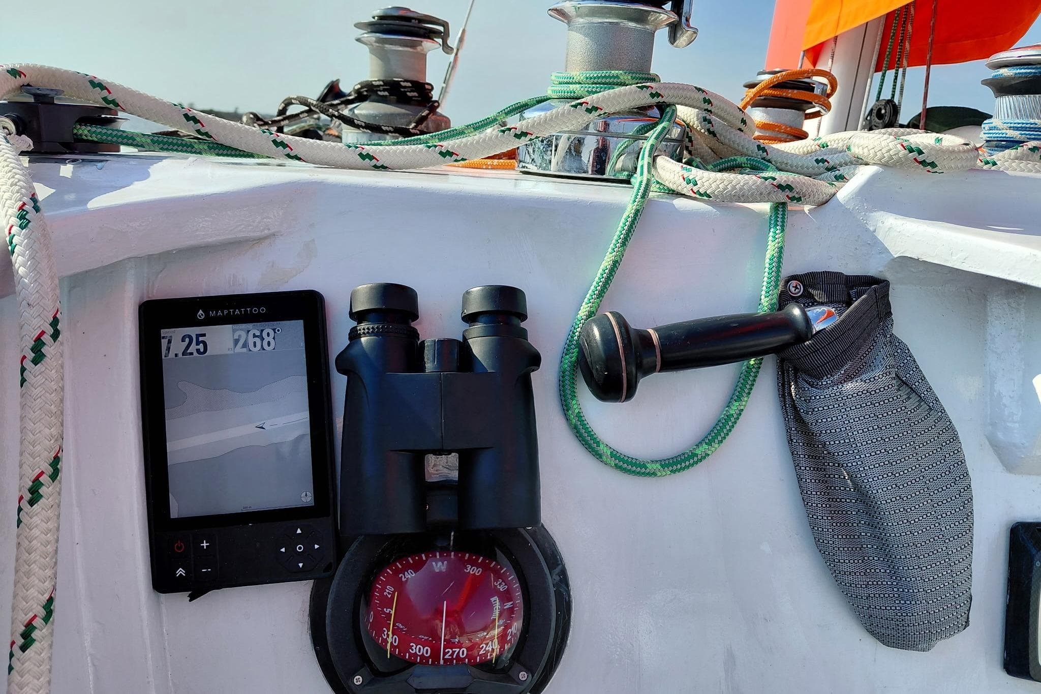 Cockpit of 1979 Newick Native sailboat with navigation tools and ropes.